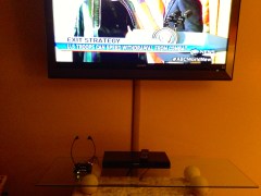 TV Ears sitting on table below Television.  You can't hear what?