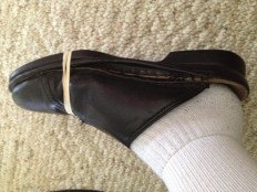 Good old childhood quick fix ... rubber bands around soles!  Just doesn't work with this style shoe!